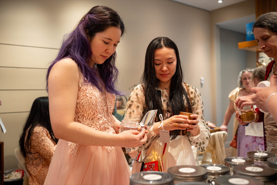 Guests filling tins at the blending table in spring 2026