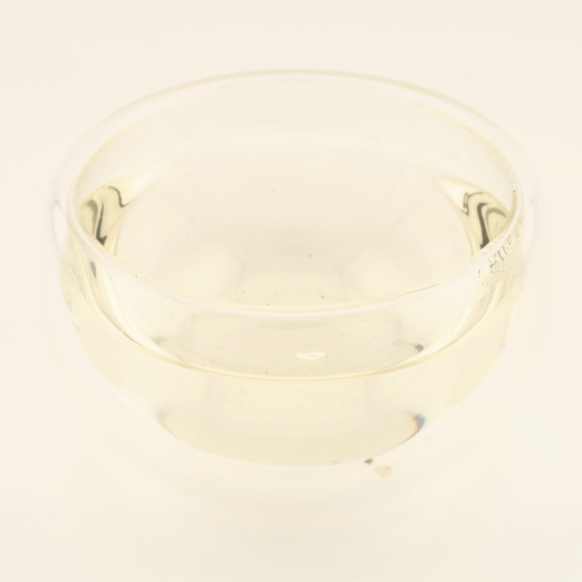 Handmade Silver Needle White Tea, brewed, in a clear glass [handmade-silver-needle-white-tea-03-liquor]